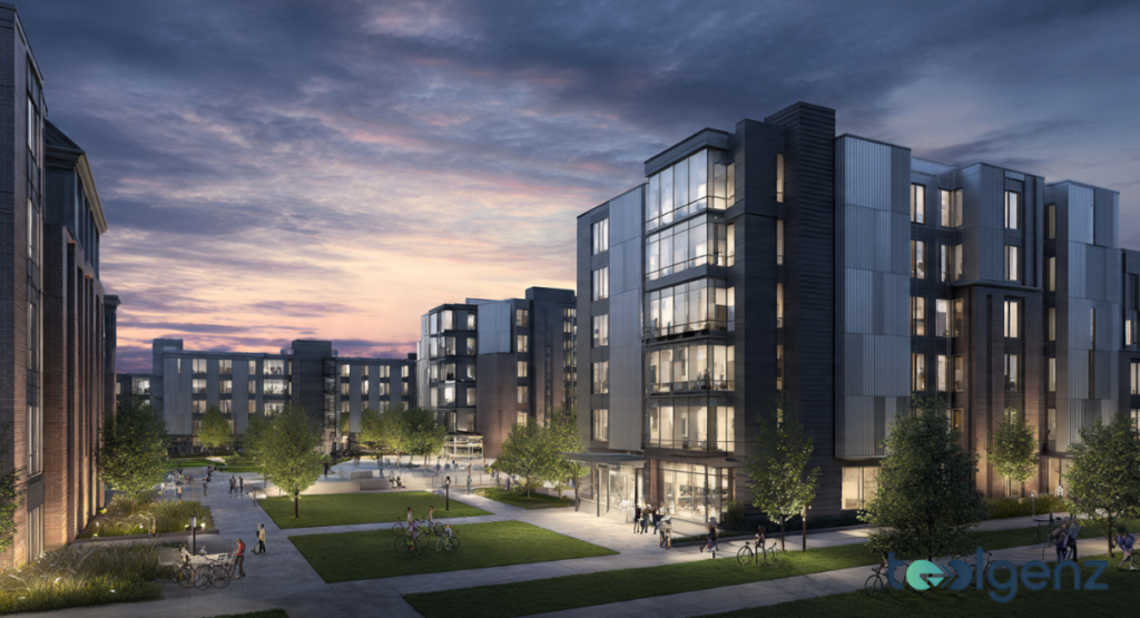 A view of modern student residential buildings surrounding a manicured green lawn at dusk. Warm lights glow from large windows, highlighting a comfortable and secure living environment for residents.
